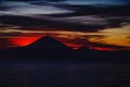 Bright tropical sunset and silhouettes of Agung volcano on the island of Bali in Indonesia. Royalty Free Stock Photo