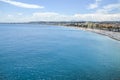 Bright turquoise sea, blue sky and old walls along beach and Promenade des Anglais in Nice, France Royalty Free Stock Photo