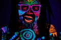 Bright UV body art, fluorescent paint, dancer man in sunglasses