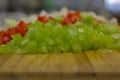 Bright vegetables diced on a wooden board. Royalty Free Stock Photo