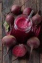 Fresh beetroot juice served in a mason jar with fresh beets on a wooden table Royalty Free Stock Photo