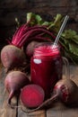 Fresh beetroot juice served in a mason jar with fresh beets on a wooden table Royalty Free Stock Photo
