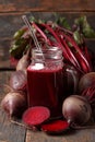 Fresh beetroot juice served in a mason jar with fresh beets on a wooden table Royalty Free Stock Photo