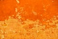 Bright and vibrant orange coloured finery, plastering part of a wall, old and vintage, weathered
