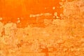 Bright and vibrant orange coloured finery, plastering part of a wall, old and vintage, weathered