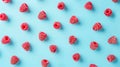 Bright vibrant red frozen raspberries on light blue background. Top view. Summer fresh wallpaper. Royalty Free Stock Photo