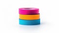 Bright and vibrant tapes in a stack, adding a pop of color to any crafting project against a clear white backdrop