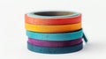 Bright and vibrant tapes in a stack, adding a pop of color to any crafting project against a clear white backdrop