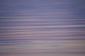 Smooth purple and blue waves. Beautiful background of rippling water.