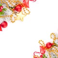 Bright vivid Christmas corner composition with red holly berries, glass baubles, golden garland and snowy Xmas tree branch Royalty Free Stock Photo