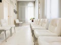 Bright waiting room in private dental clinic, white waiting hall interior in private hospital