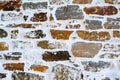Bright wall from natural rectangular stone with white lime plaster Royalty Free Stock Photo