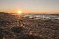 Bright warm orange sunset on the Black Sea coast with warm dark foamy surf waves Royalty Free Stock Photo