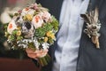 Bright wedding bouquet in hands of the groom Royalty Free Stock Photo