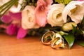 Bright wedding bouquet of summer flowers with wedding rings