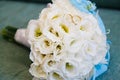 Bright wedding bouquet of summer flowers with wedding rings