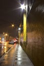 Bright Wet City Sidewalk and Street At Night Royalty Free Stock Photo