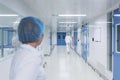 Bright, white with blue doors, a sterile corridor in a medical facility.