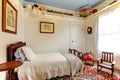 Bright white boys room with wood bed, rocking chair and coloufu