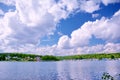 Bright white clouds in the blue sky over the Bay Siberian river Angara. Royalty Free Stock Photo