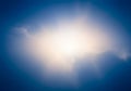 A bright, white, glowing cloud at the center of the image is surrounded by a deep blue Royalty Free Stock Photo