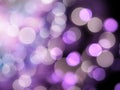 Bright white illumination with glowing white and purple blurred lights on a black background Royalty Free Stock Photo