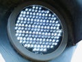 Bright white LED traffic control light and signal in round shape with arching metal hood