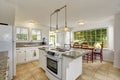 Bright white modern kitchen interior with island and dining area Royalty Free Stock Photo