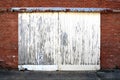 White painted peeling warehouse shipping double doors Royalty Free Stock Photo