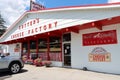 Bright white and red building invites visitors to come in to buy cheese, Cutter\'s Cheese Factory, Batavia, New York, 2022