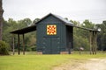 A bright windmill pattern quilt on a painted wooden pole barn in rural Georgia, USA Royalty Free Stock Photo