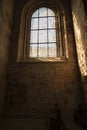 Bright window, with beautiful details. Interior of a medieval building made of rock. Warm light. Interior of Nossa Senhora da