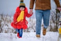 Bright winter day dad with daughter in the woods with their dog, fun walk in the snowy forest Royalty Free Stock Photo