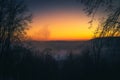 Bright winter sky after sunset. Frozen river, fog, trees Royalty Free Stock Photo