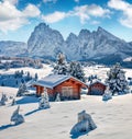 Bright winter view of Alpe di Siusi village with Plattkofel peak on background.