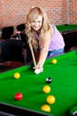 Bright woman playing pool Royalty Free Stock Photo