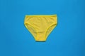 Bright women`s panties on a bright blue background. Women`s underwear