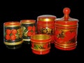 Bright wooden kitchen utensils on black background.Khokhloma is an ancient Russian folk craft of the 17 century.