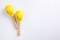 Bright wooden maracas on white background, top view. Montessori musical toy Royalty Free Stock Photo
