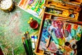 Colorful workplace of the artist with oil paints - vertical