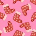 Bright xmas seamless doodle pattern with ornamental red winter shoes elements. Pink background