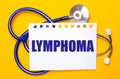 On a bright yellow background, a blue stethoscope and a sheet of paper with the text LYMPHOMA. Medical concept