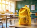 Bright Yellow Backpack on a Modern School Desk A Colorful Classroom Setting for Learning Resources and School Supplies Royalty Free Stock Photo