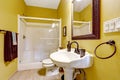 Bright yellow bathroom with glass door shower