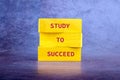 Concept of Education Represented by Yellow Blocks With the Phrase Study to Succeed on a Textured Background Royalty Free Stock Photo