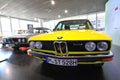 Bright yellow BMW 5 series classic sedan on display at BMW Museum