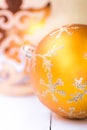 Bright yellow Christmas tree bauble with sparkling silver snow flake ornament, golden angel, flare, magic, greeting card Royalty Free Stock Photo