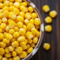 Bright yellow corn kernels fill a ceramic bowl with a speckled brown and white rim. The Royalty Free Stock Photo