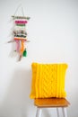 Bright yellow crocheted pillow in the interior