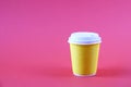 Colorful simplistic minimal composition with heat proof paper coffee cup. Take out tea mug with plastic cap. Coffee shop concept. Royalty Free Stock Photo